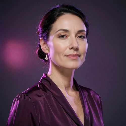 Portrait of a poised woman with a low chignon and drop earrings in violet light